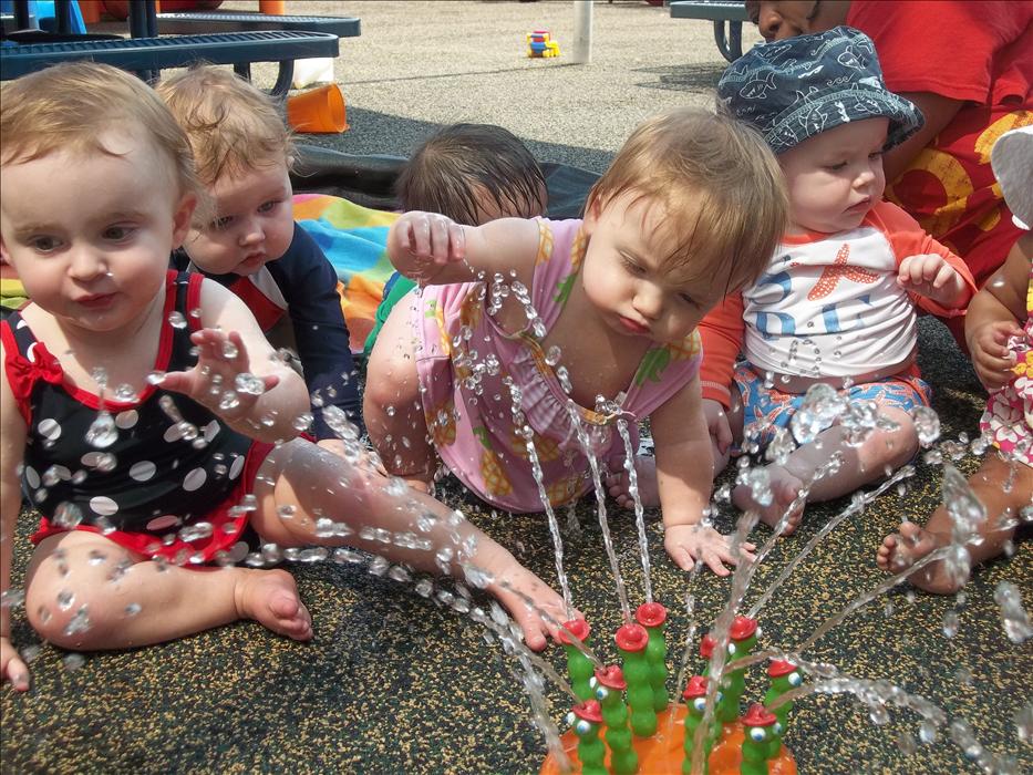 It's amazing what infants can do!  Our infants, 6 weeks - 15 months old, participate in gross motor and sensory activities (like Water Wednesday!), create art projects, and develop their social emotional skills with their teacher's and classmates!