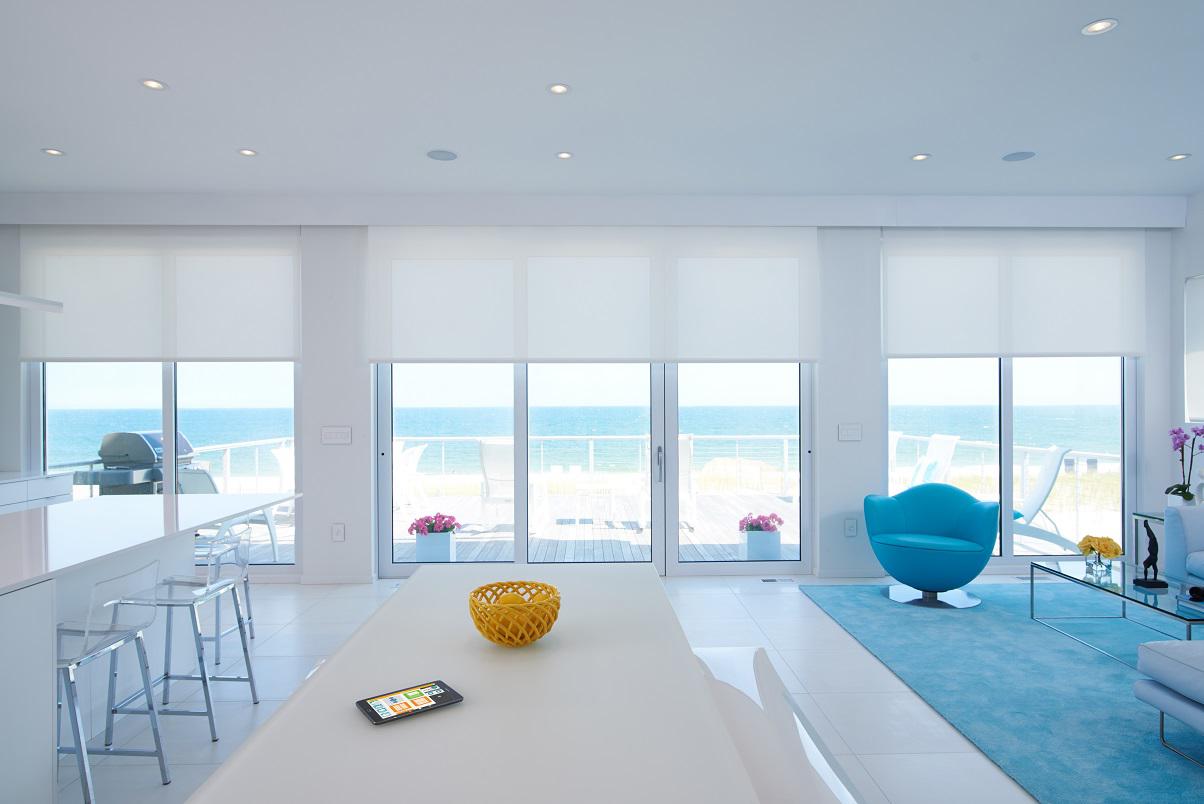 Our translucent Motorized Shades make a perfect choice for these gorgeous sets of  windows in Mission Beach as they give absolute privacy but also allow an ample amount of natural  light in. Don't they just go perfectly in this room of all-white furniture?   BudgetBlindsPointLoma   MotorizedShades  