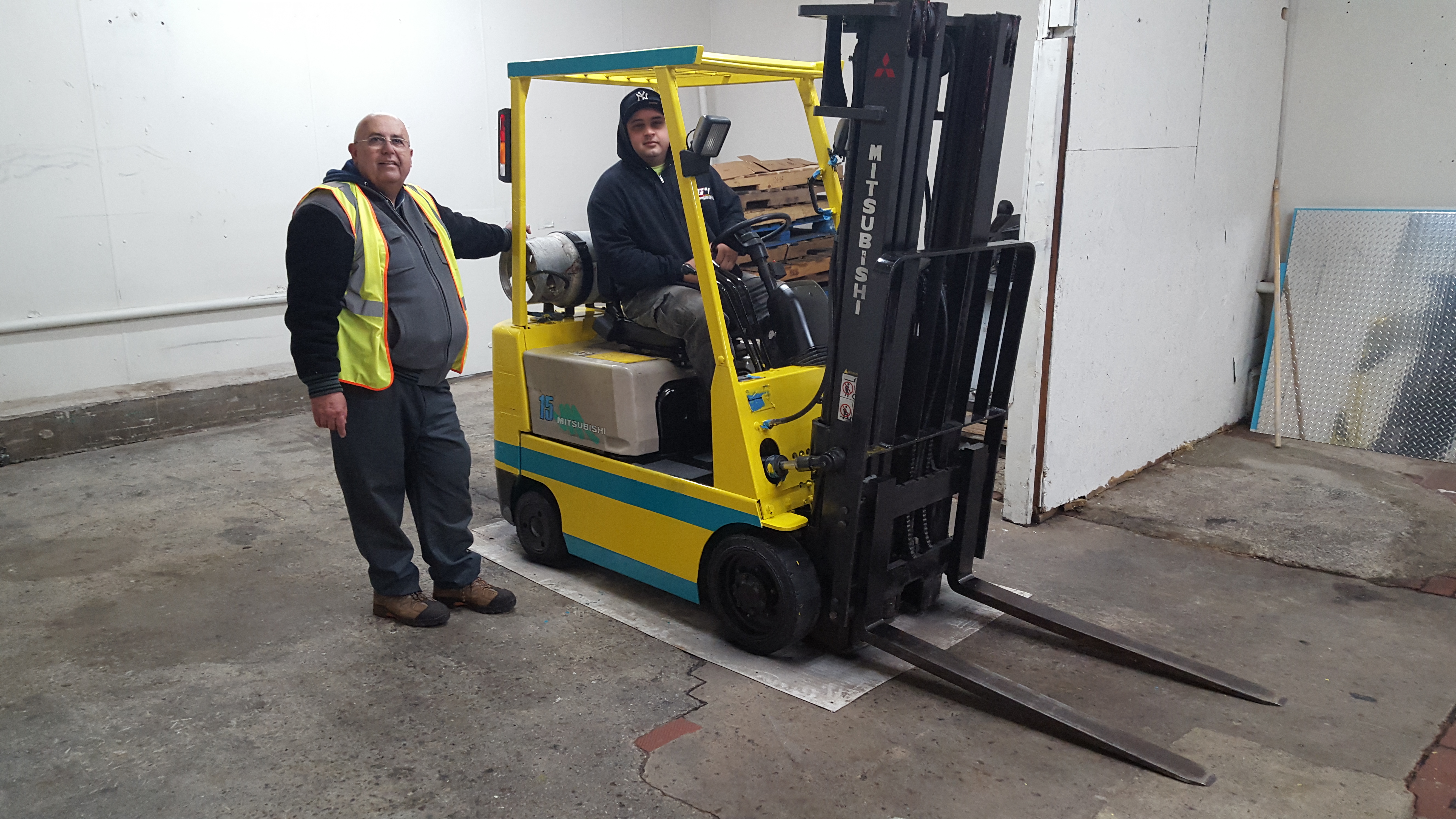 E-Z Wheels Driving School Staff with a forklift