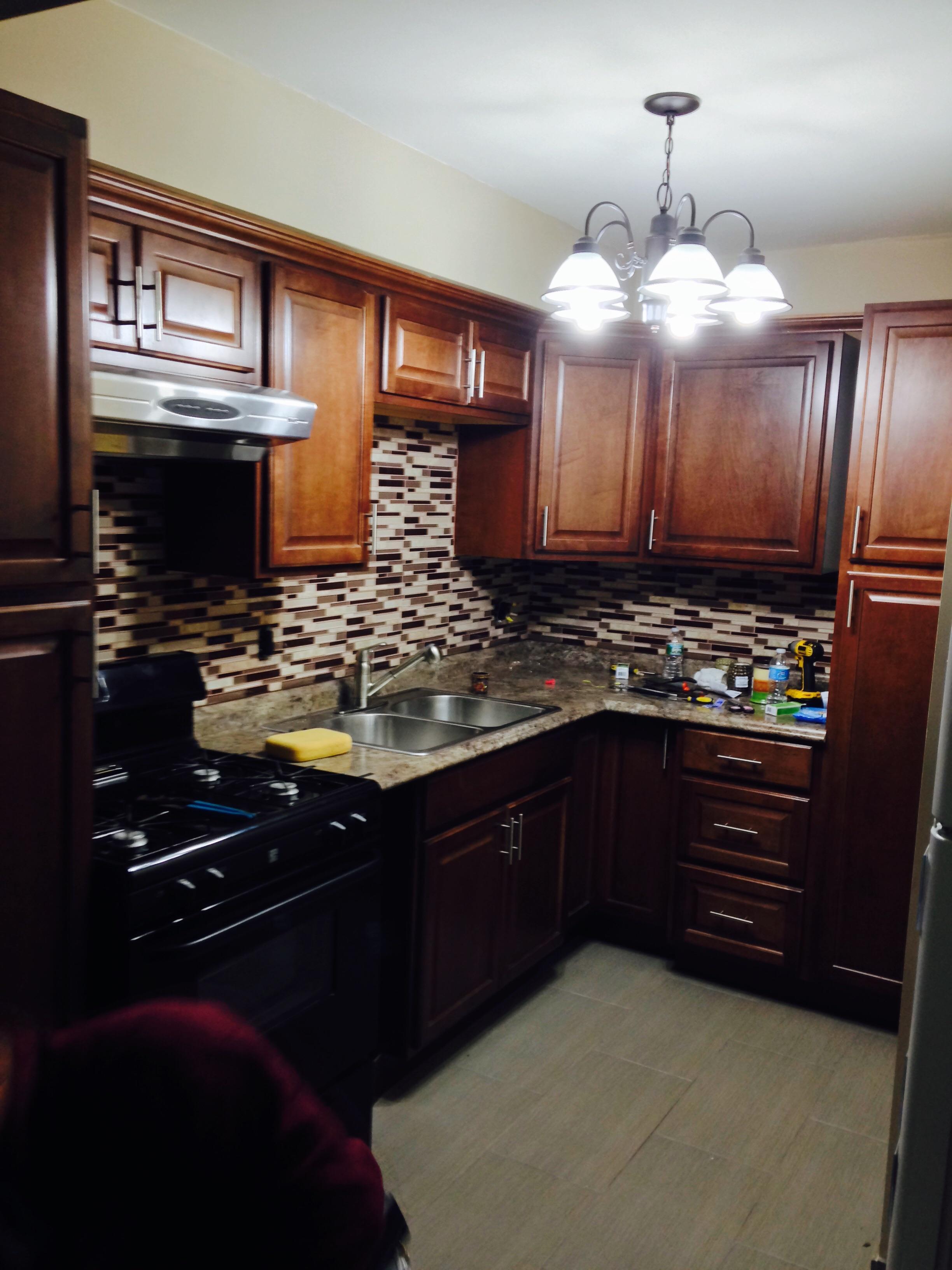 New floor, cabinets, backsplash, and lighting