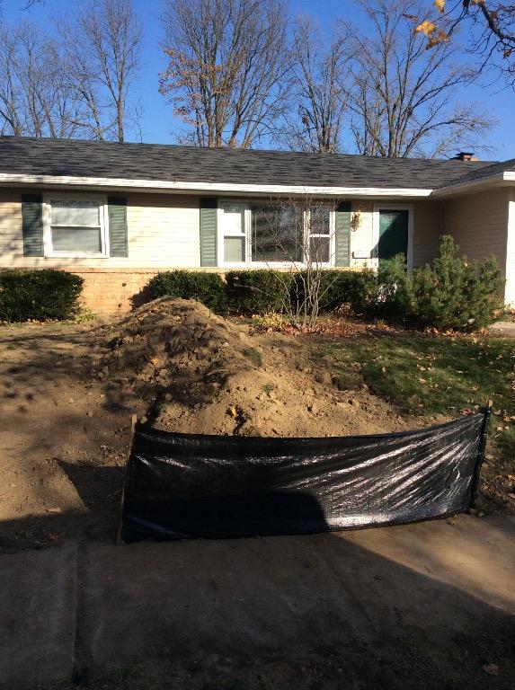 Main sewer line excavation after the trench was backfilled.