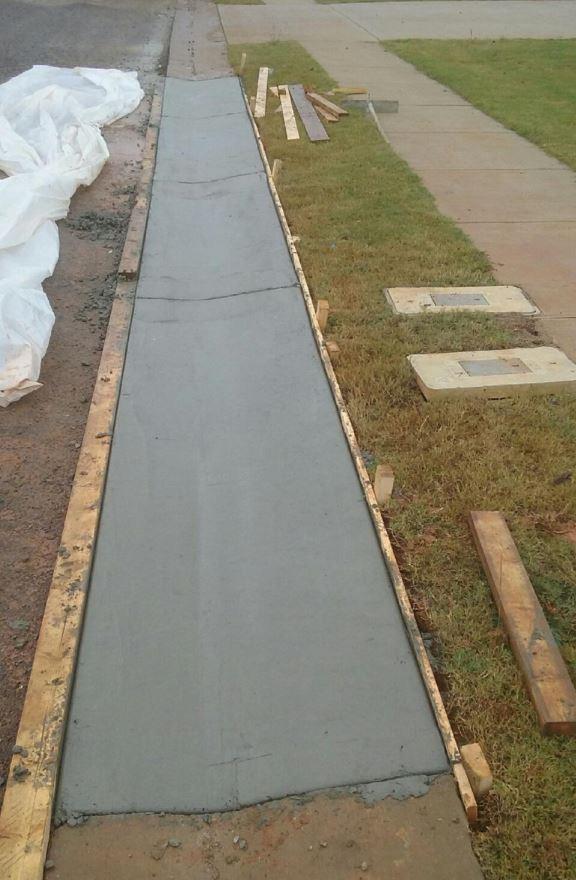 Concrete Sidewalk Curb poured by NM Construction in Moody, AL