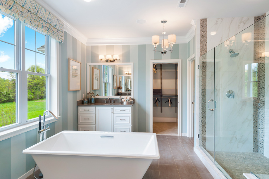 Lavish primary baths with free-standing soaking tubs and luxe showers