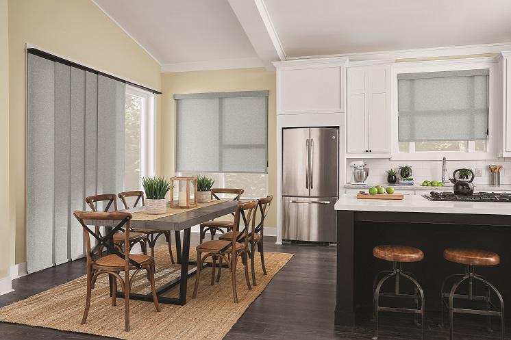 Bring your open floor plan together with flawlessly coordinated window treatments. This kitchen and dining area comes together with attractive Roller Shades and Sliding Panel Track Blinds for the patio door.  Budget BlindsParamusWestwood  PanelTrackBlinds  BlindedByBeauty RollerShades   ShadesOfBeau
