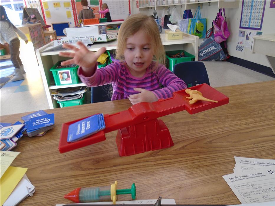 Bliss is discovering which object is heavier during Math and Manipulative time in our Pre-K class!