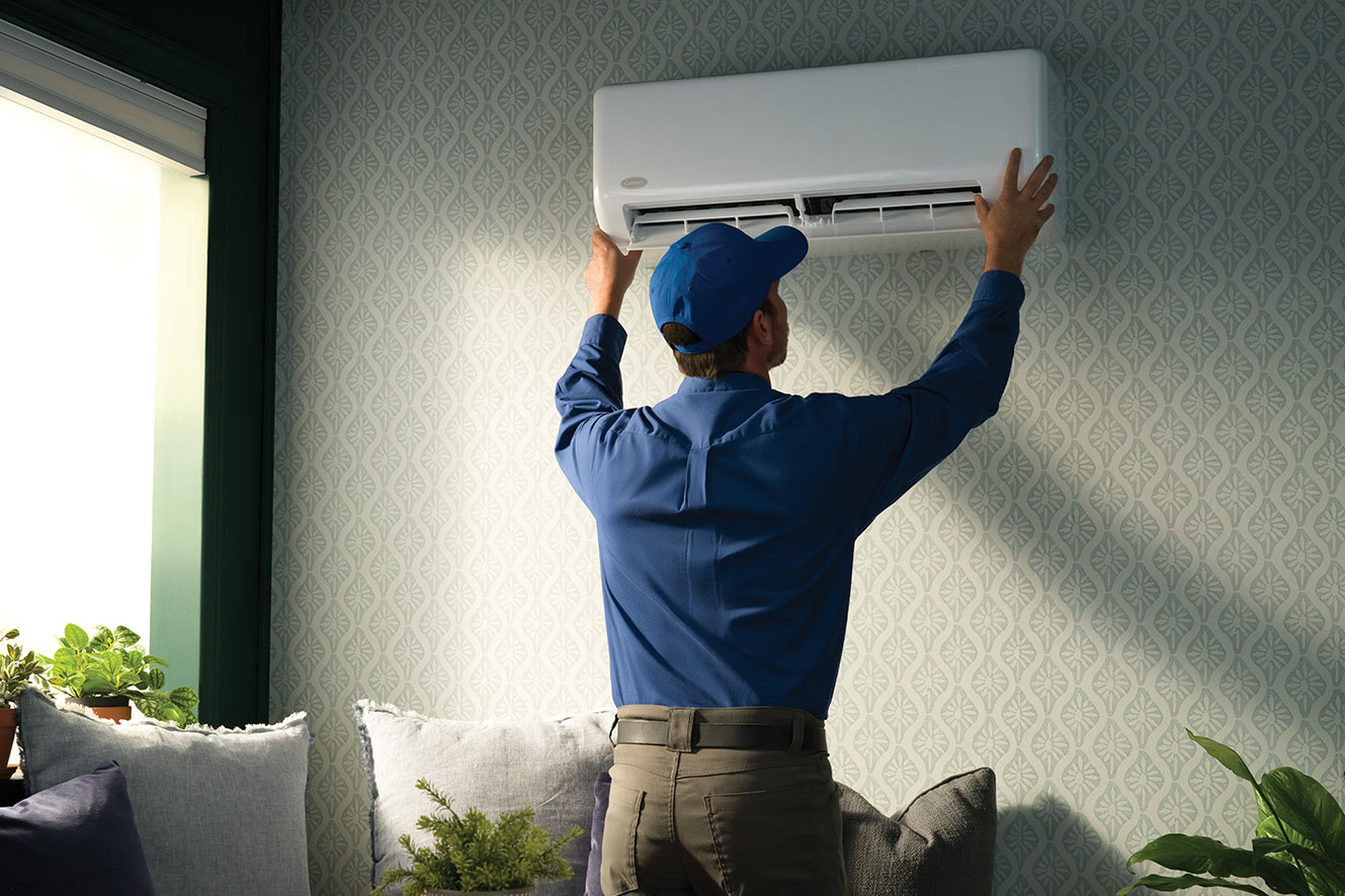 A Carrier dealer installing a ductless highwall unit