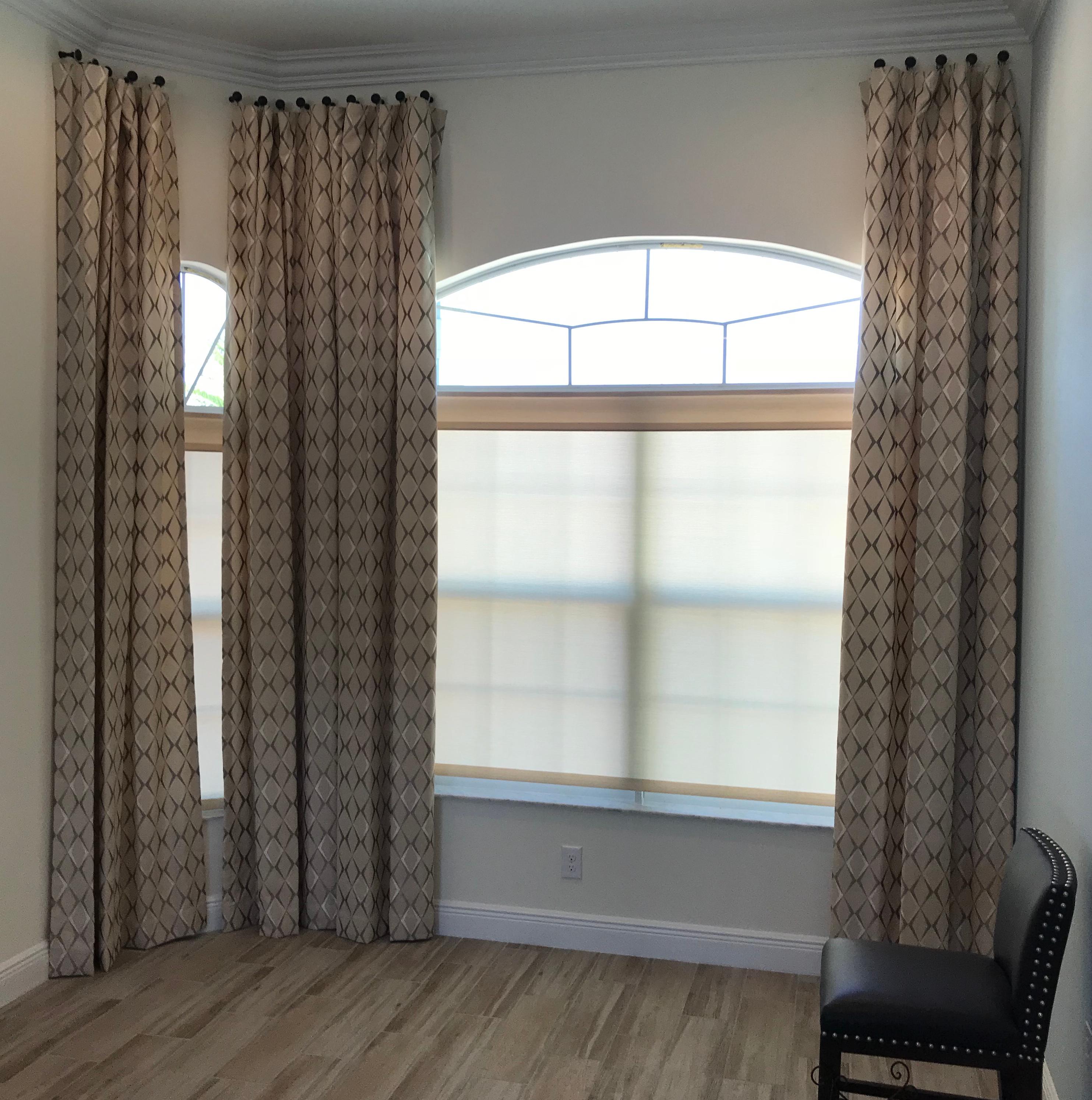 Patterned drapery and sheer shades are a stylish and functional combination. The shades provide privacy and heat protection while drapery panels are an eye-catching element of this Vero Beach home.