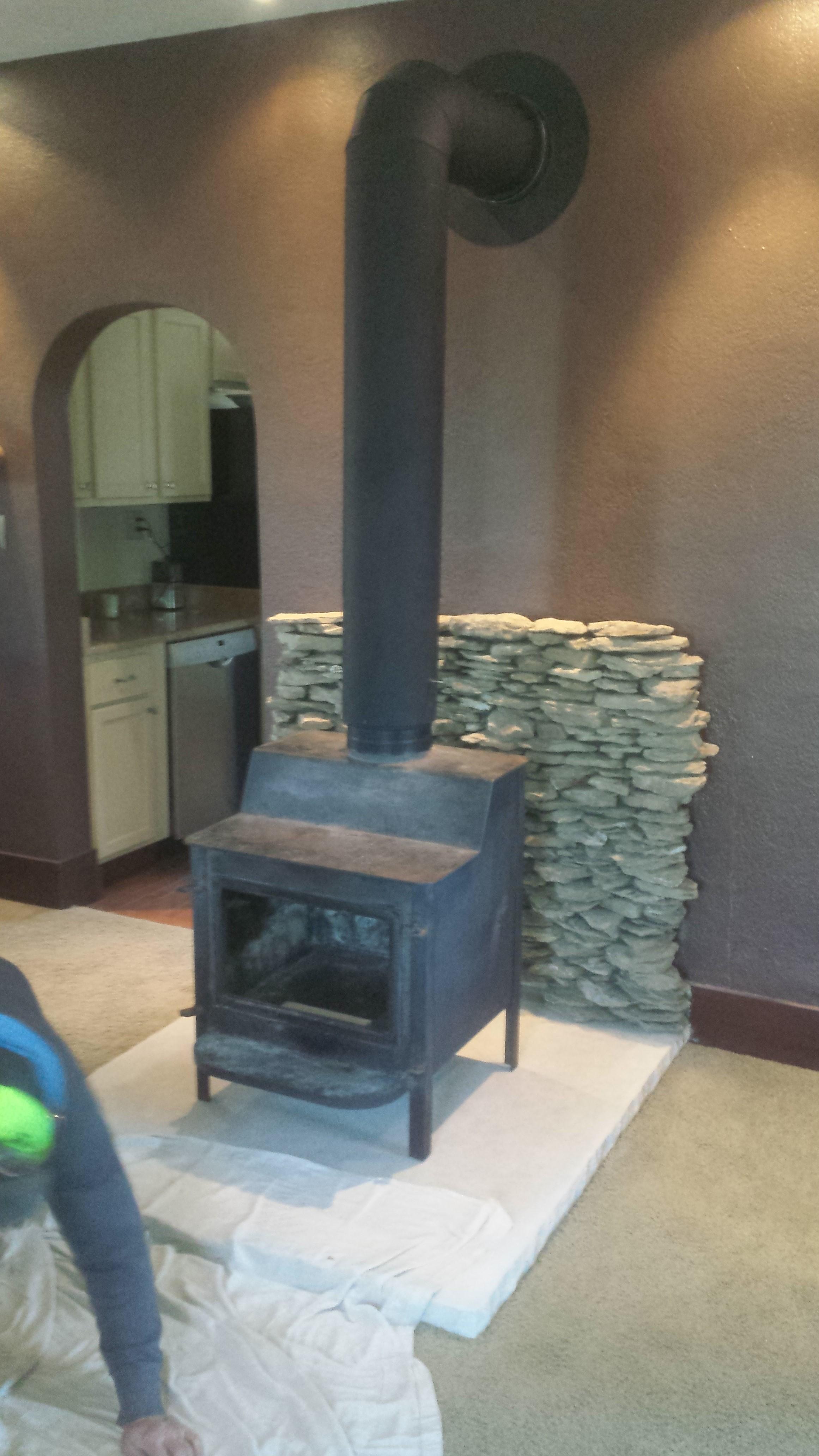 We cut out the carpet, installed a 600 pound piece of limestone as a hearth, full bed Missouri ledge stone wall protection, and wood burning stove with chimney.