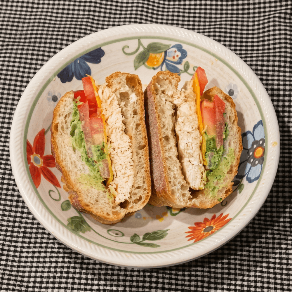 Grilled Chicken with Cheddar, Plum Tomato, Green Goddess Dressing on a Baguette