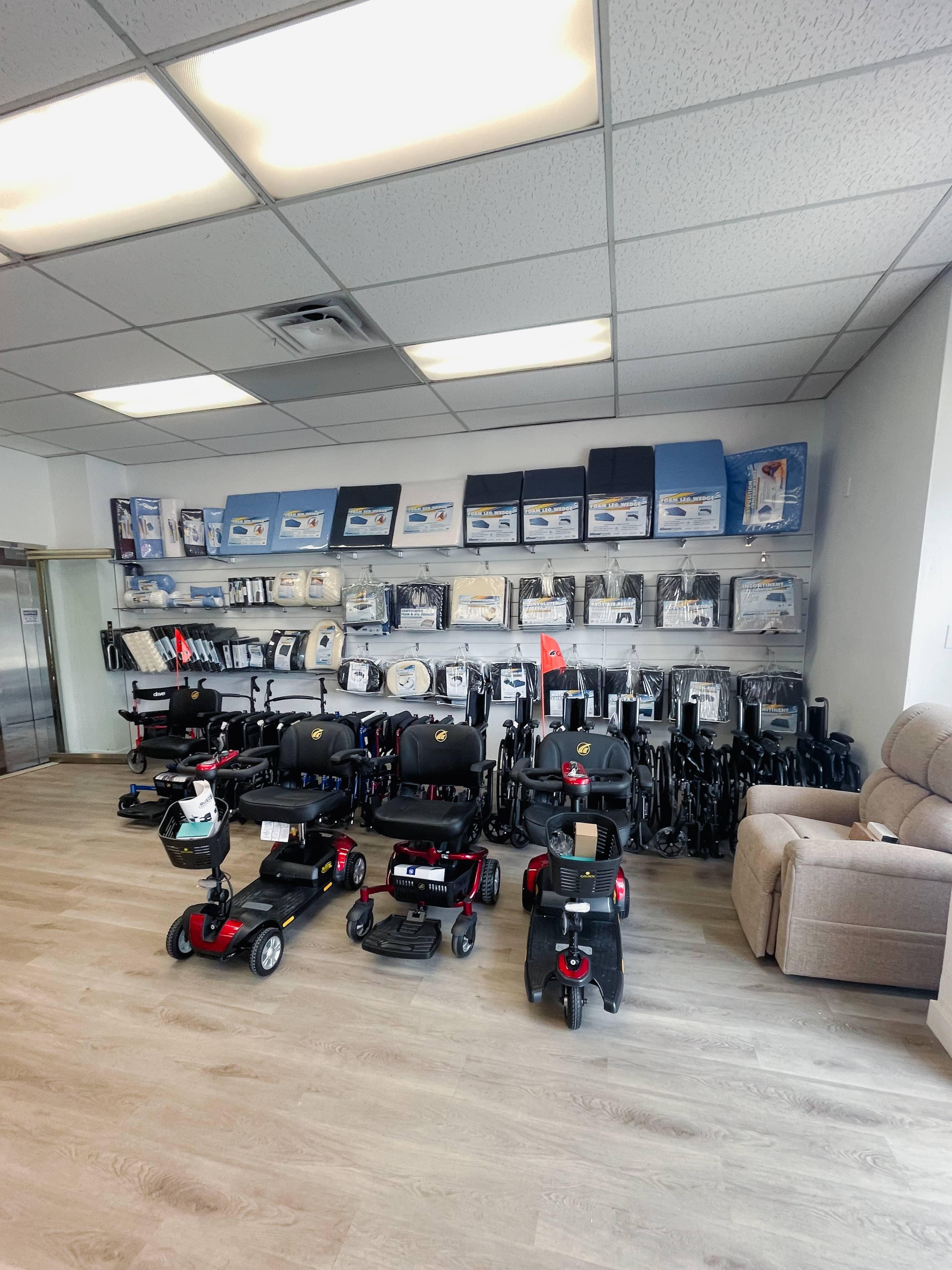 View of electric scooters, wheelchairs, and a wall lined with medical cushion products.