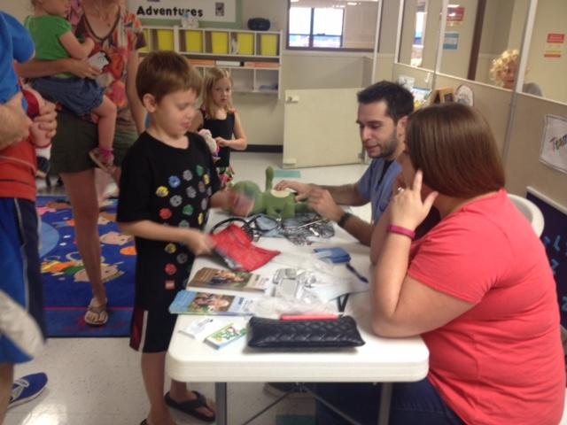 Getting his frog a check up by the Veterinarian from Bay Glen Animal Hospital at our KinderCare Health and Safety Fair.
