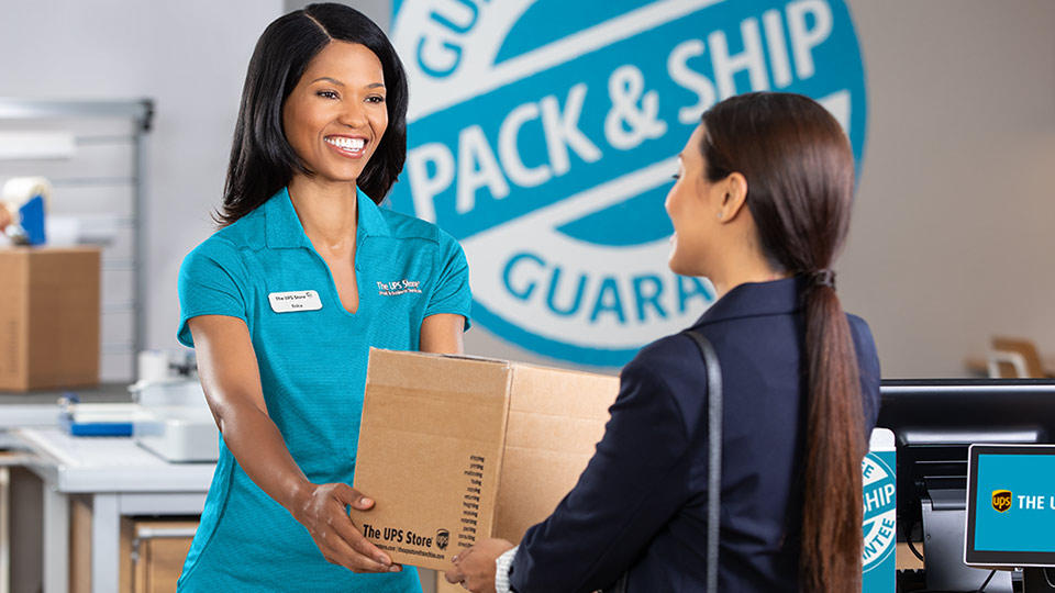 woman shipping a package at The UPS Store