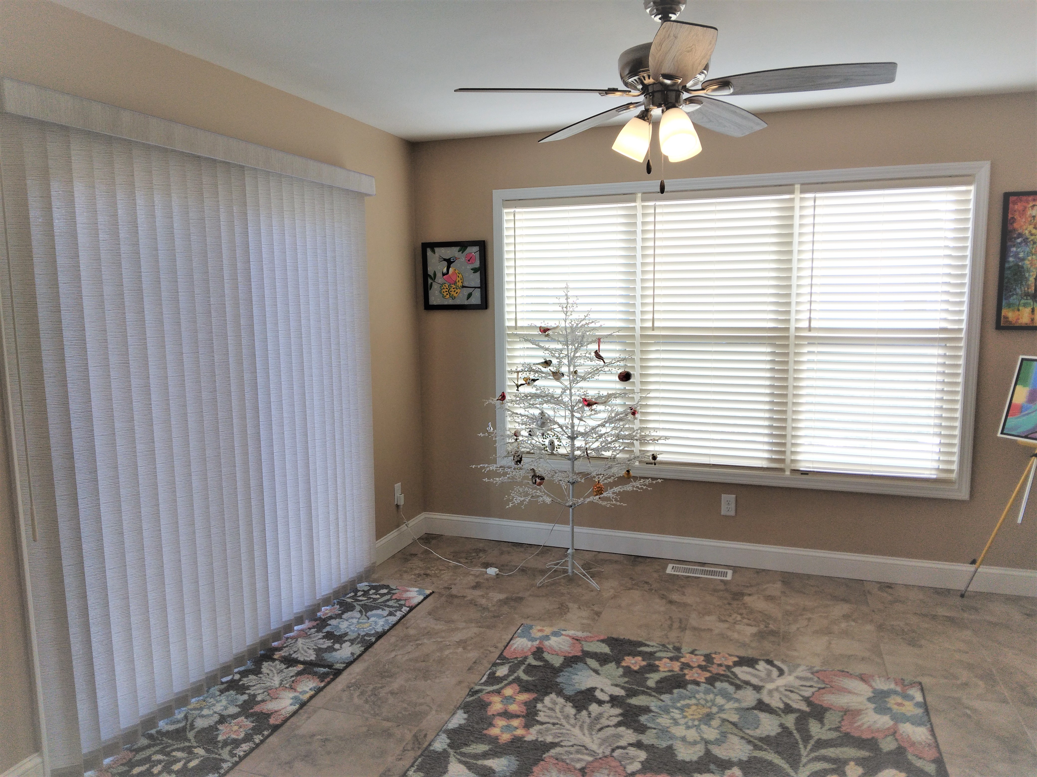 The faux wood blinds on the windows and the vertical blinds on the sliding door create a perfect look for the sunroom in this beautiful Springfield Illinois home.  BudgetBlinds  Blinds  VerticalBlinds  WindowCoverings  SpringfieldIllinois  Springfield
