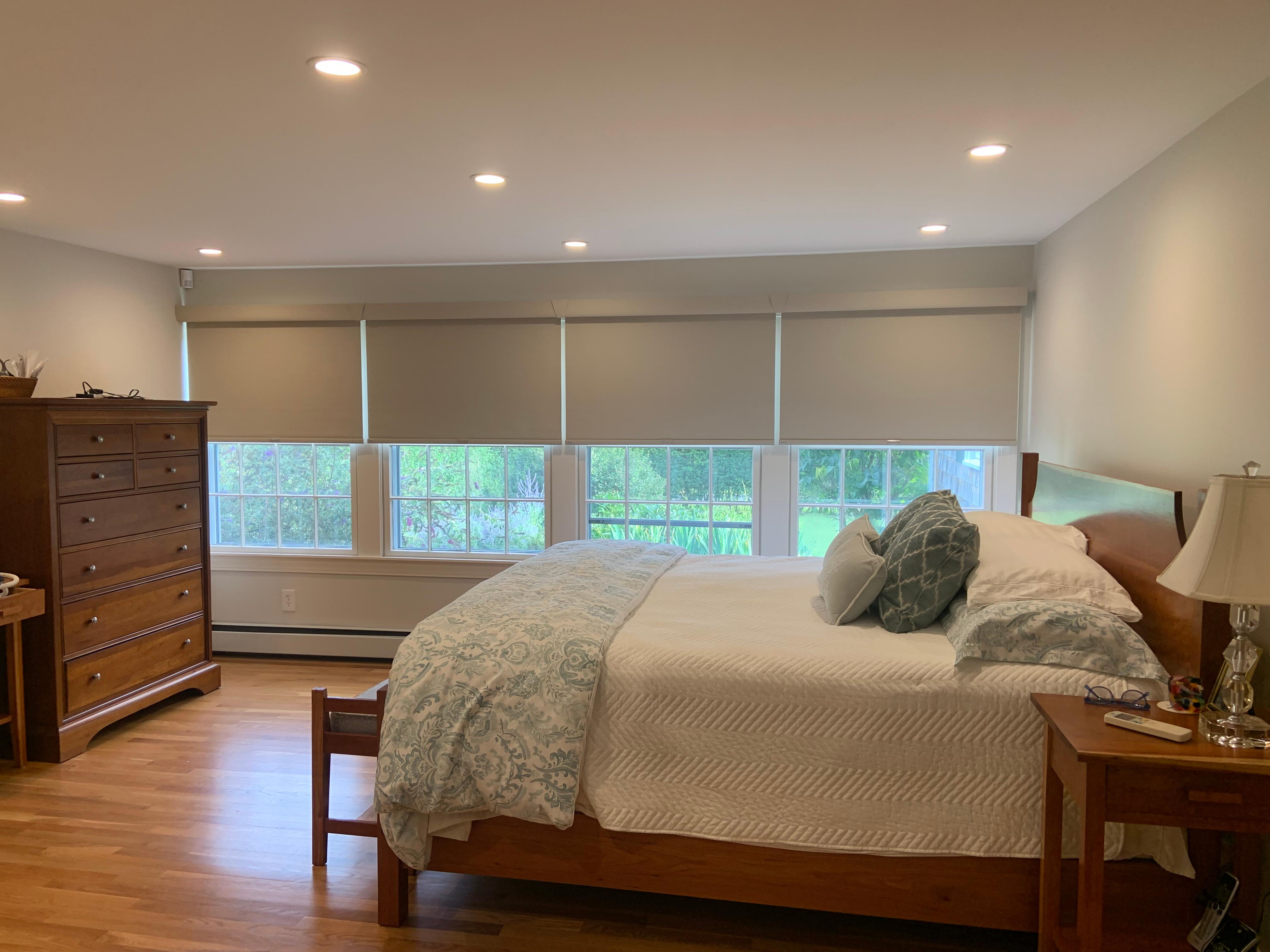 Betcha can't tell these windows are all different sizes! Our expert designer, Stacey, was able to make them look seamlessly uniform! We love these roller shades in this lovely Bristol, RI bedroom.