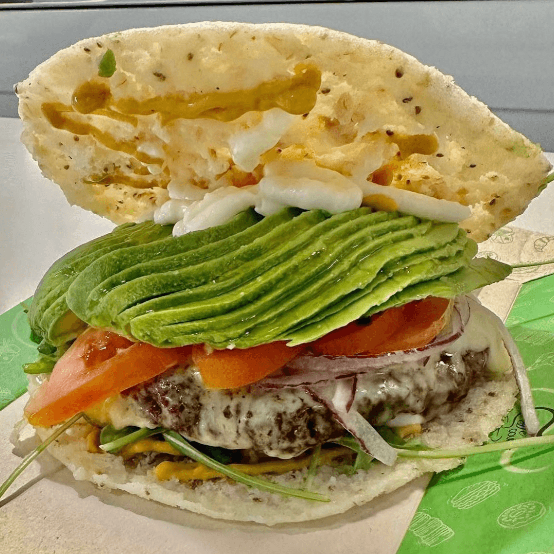BEEF AREPA BURGER (Arepa, gouda, tomato, onion, arugula, ketchup, mayo, mustard)