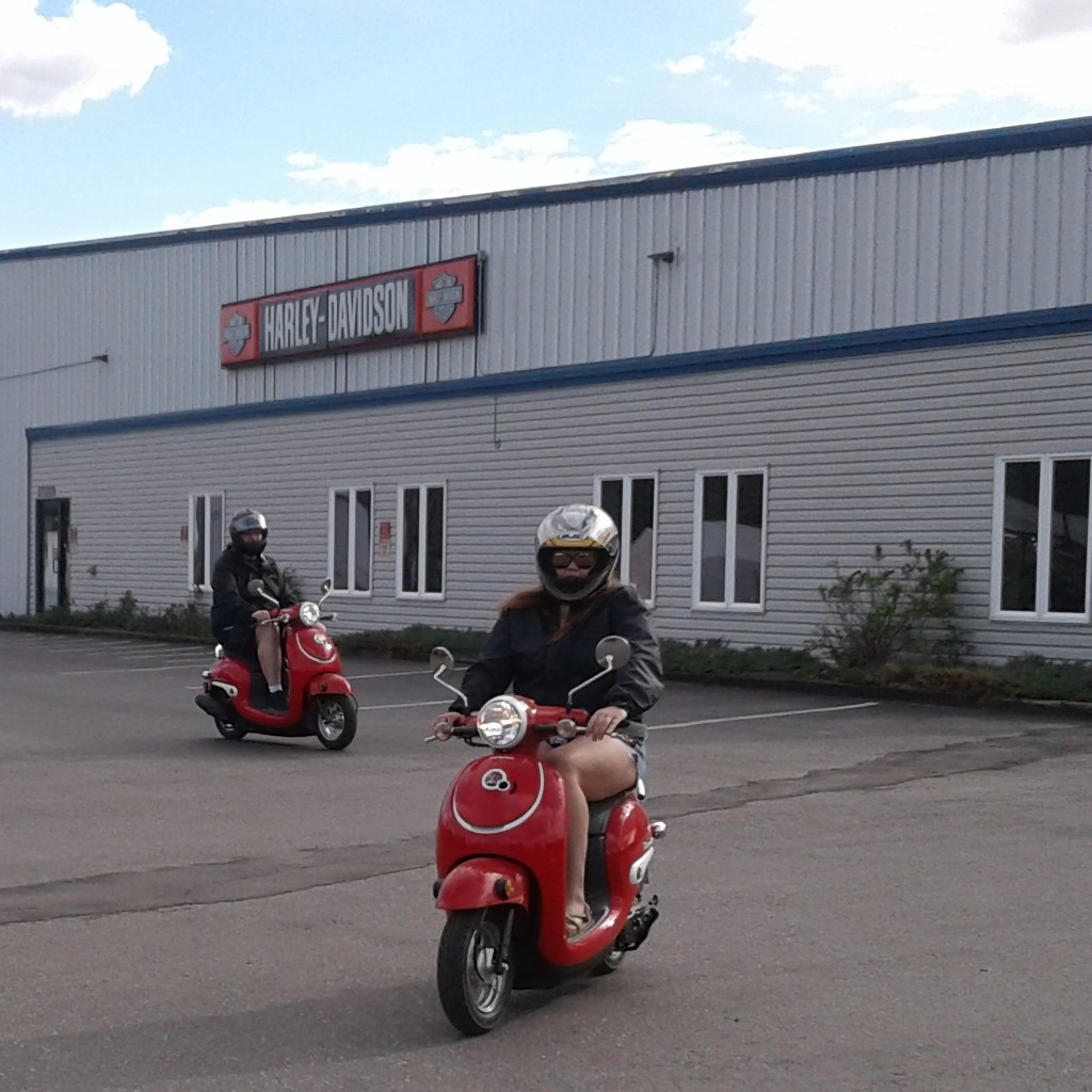 Katy and Dev trying out the scooters.