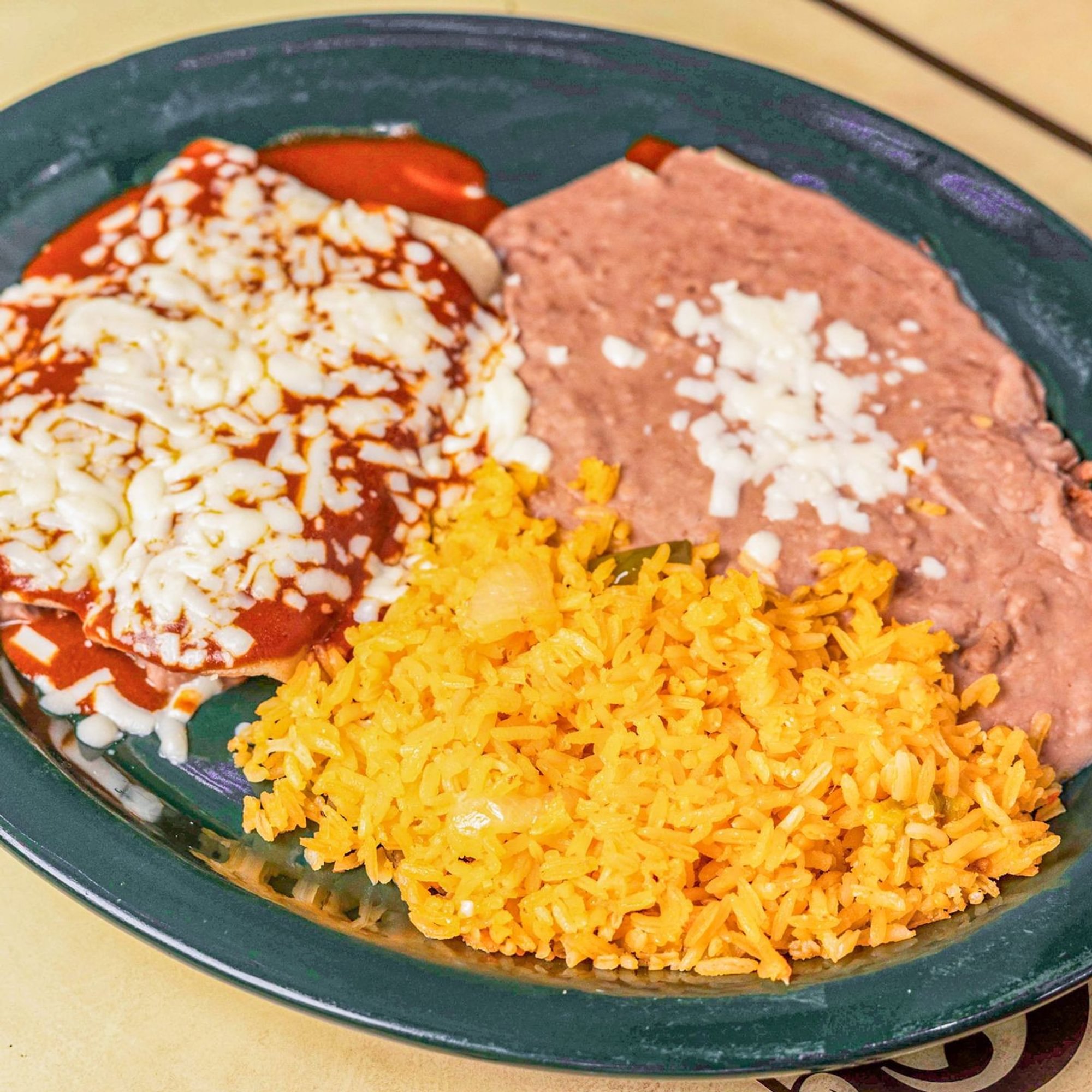 4. Two Enchiladas, Rice and Refried Beans