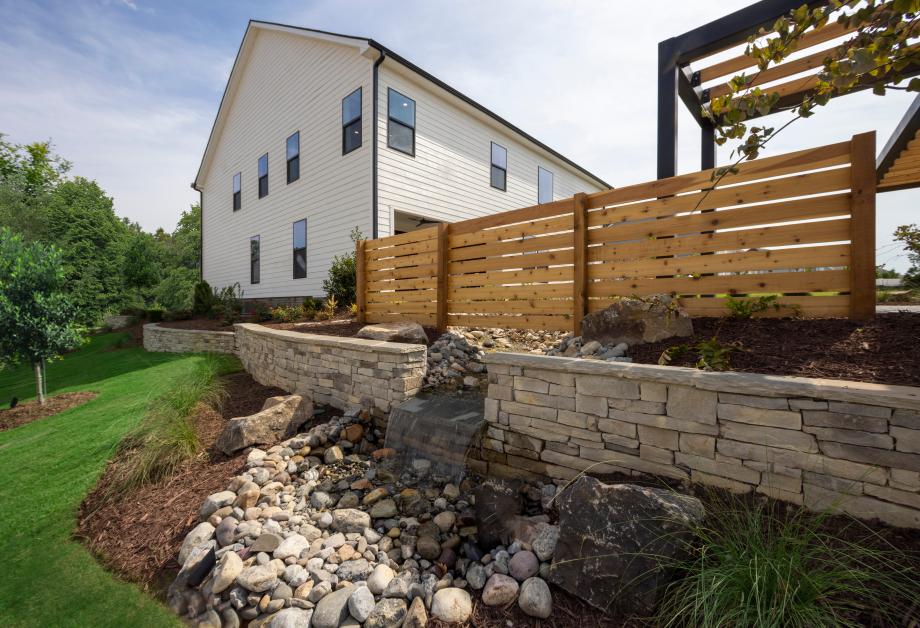 The landscaping package with paver walkways and driveway creates additional curb appeal