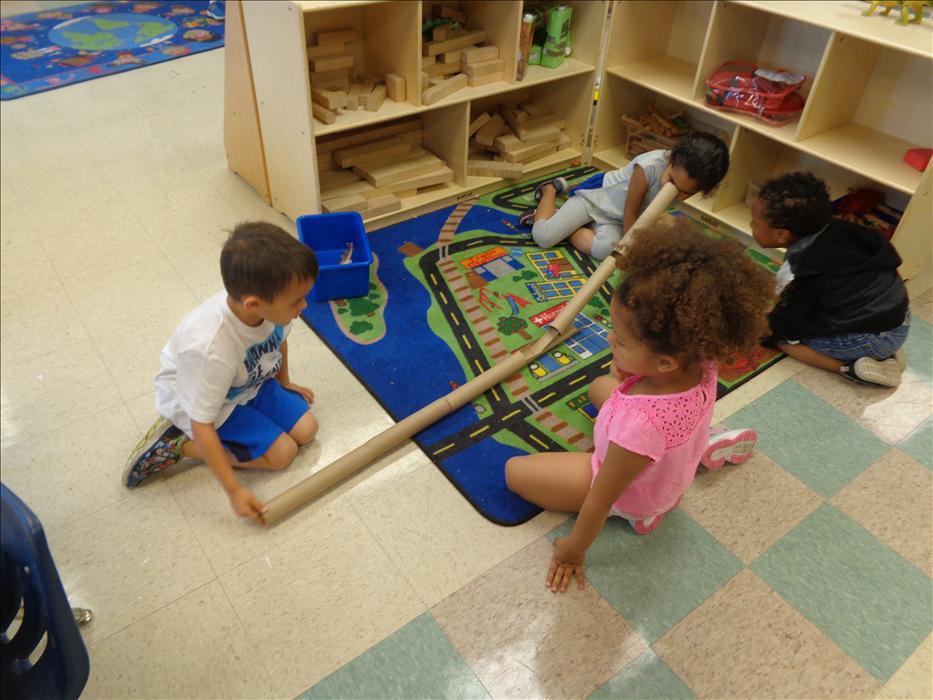 Our prekindergarteners use team work to build a tunnel for their marble to travel through.