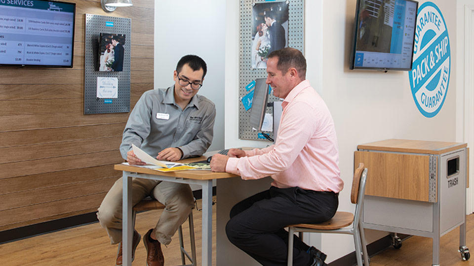 Associate sitting with customer during print consultation