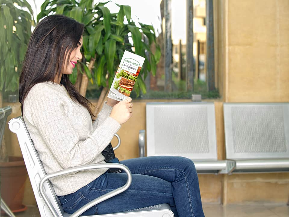 Woman reads full color brochure