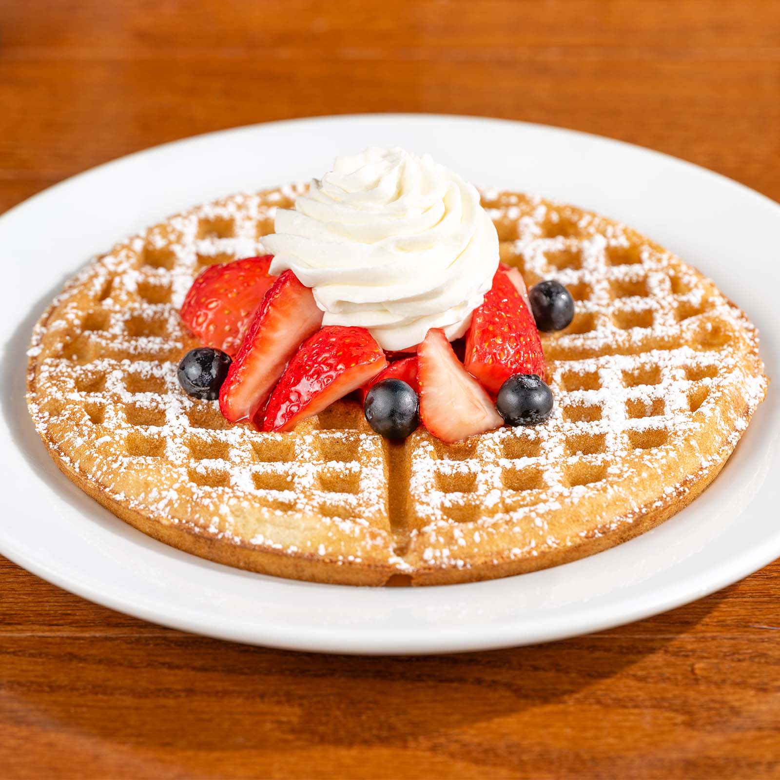 Waffle with Berries, Powdered Sugar, and Whipped Cream
