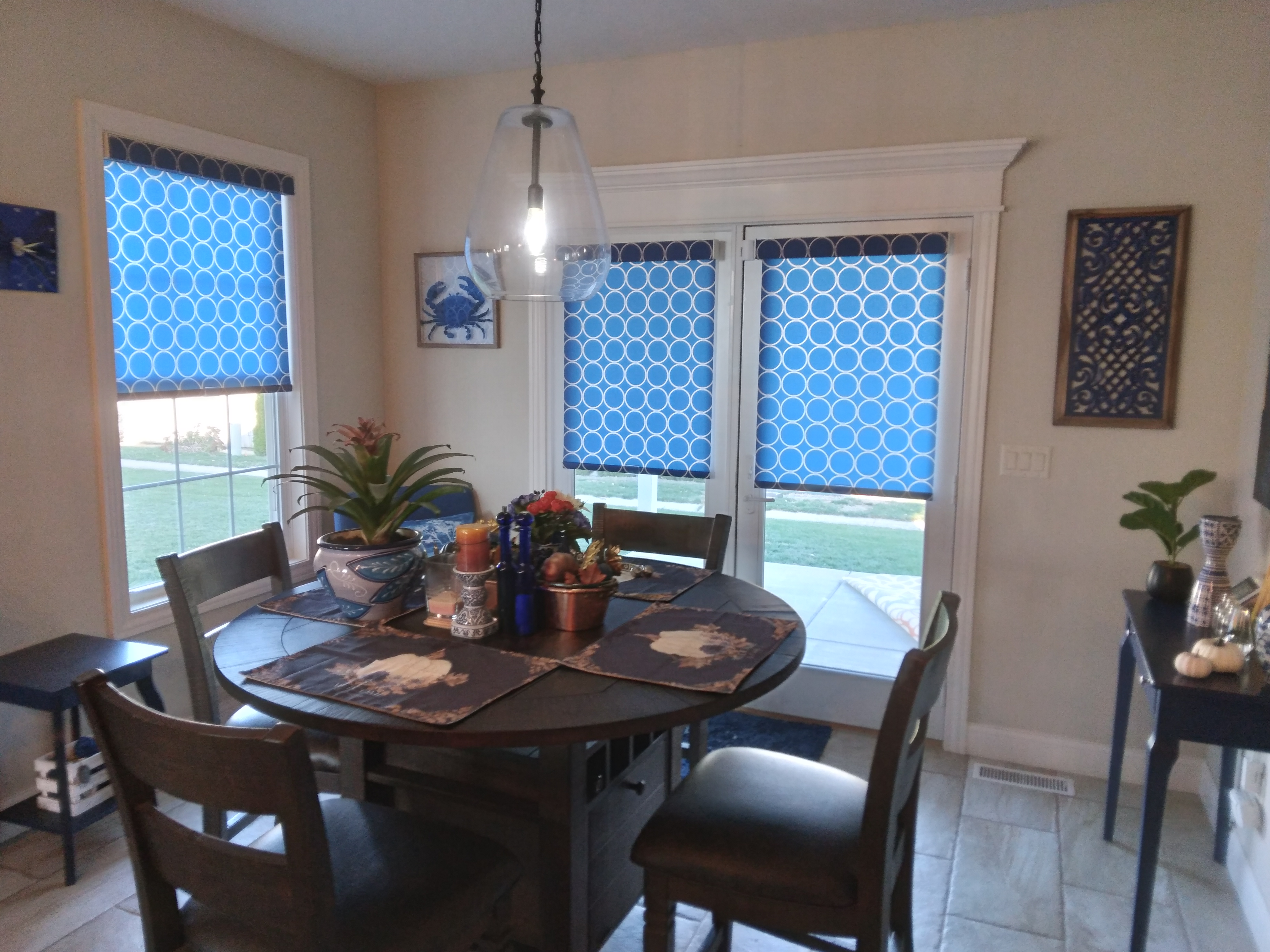 Cordless, light filtering roller shades in Springfield Illinois dining room.  BudgetBlinds  WindowCoverings  Shades  RollerShades  SpringfieldIllinois