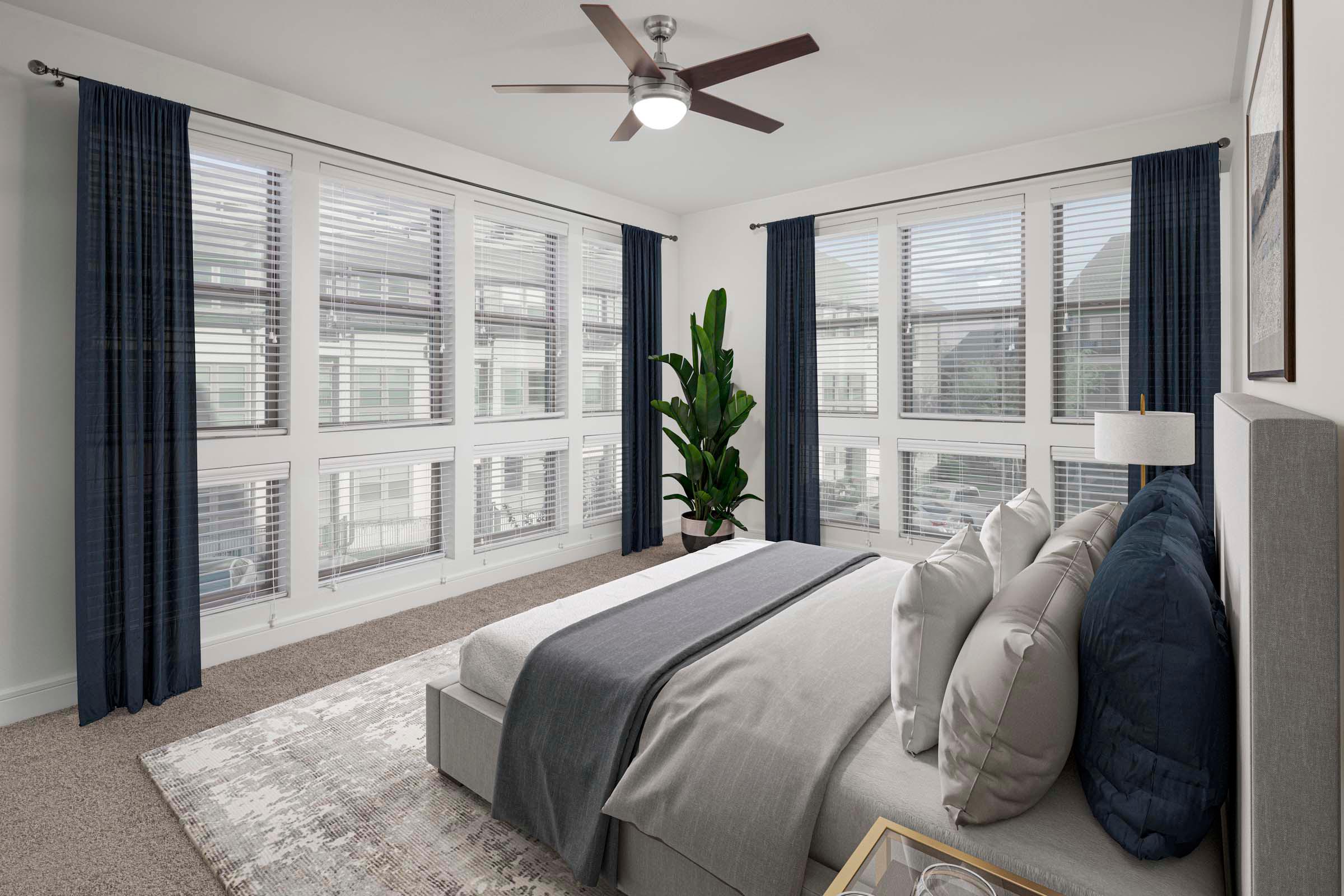 Villas townhome bedroom with carpet and large windows at Camden Greenville