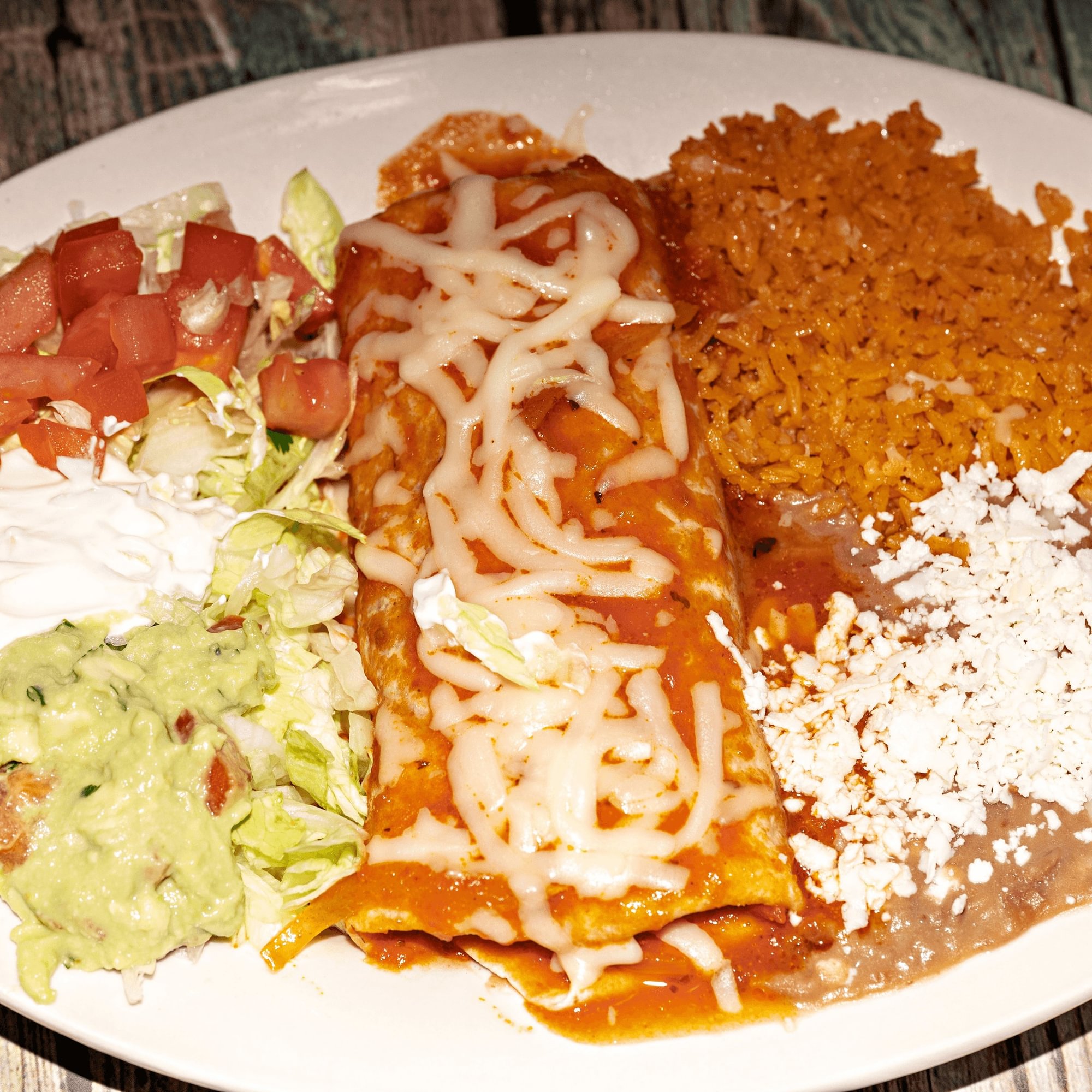 3 - Burrito covered with red sauce, cheese