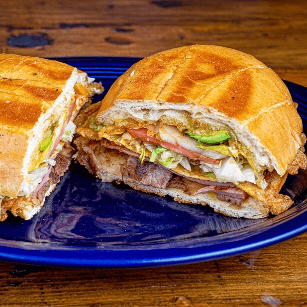 Cubana Torta (Steak, Pork, Ham, Egg) / (Carne, Pierna De Cerdo, Jamón, Huevo)