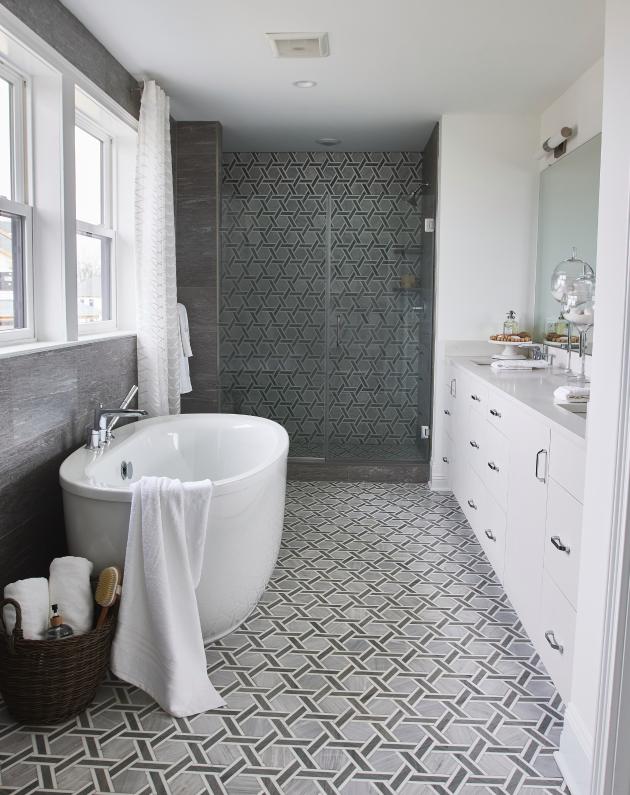 A relaxing and spacious primary bath has a free-standing tub and oversized shower