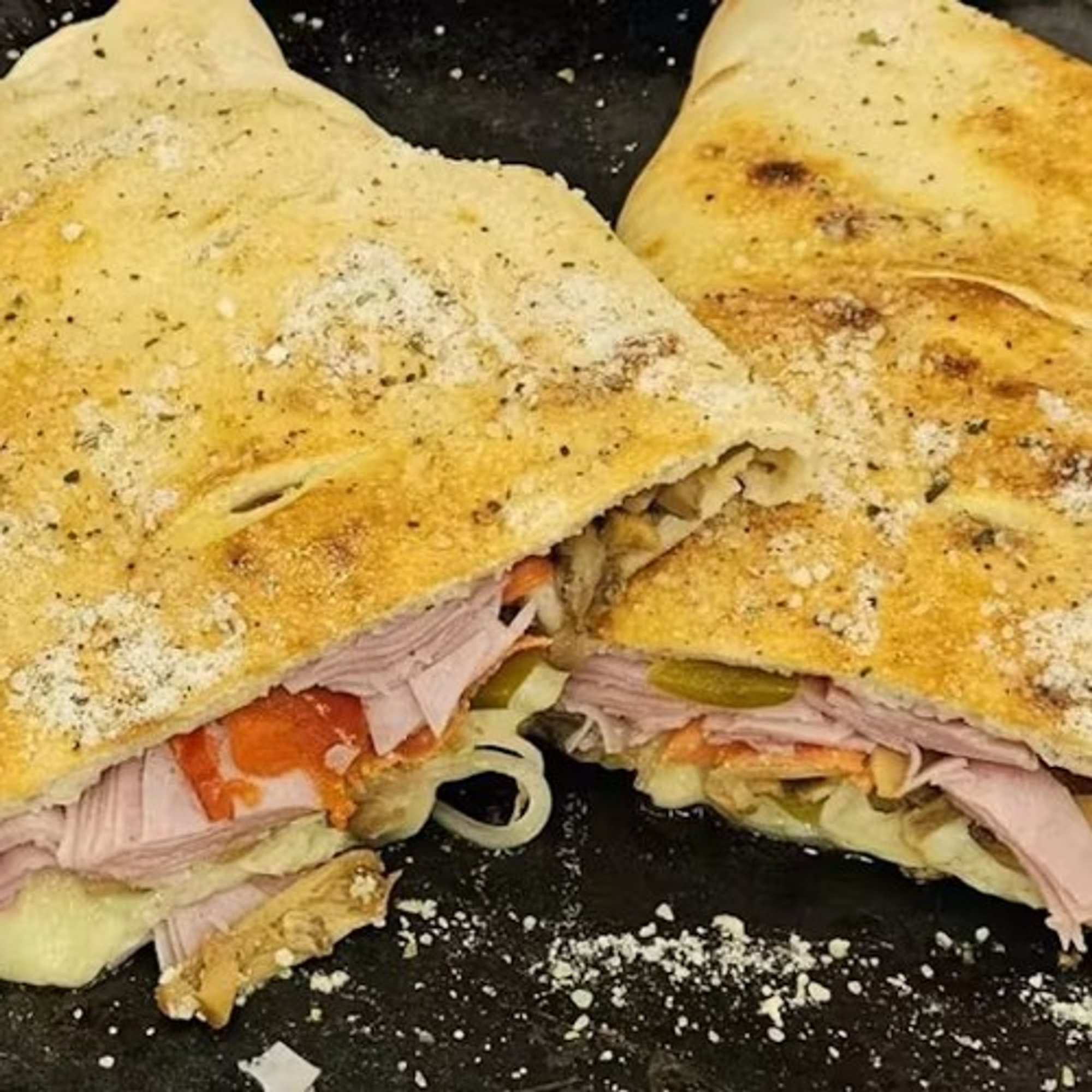 House Stromboli (Pepperoni, Salami, Ham. Mozzarella, Sweet Pepper, Mushrooms, and Onions)