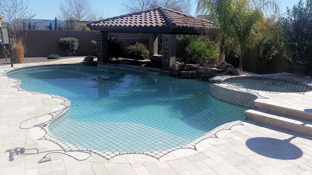 The Katchakid pool safety net covering a pool and raised spa.