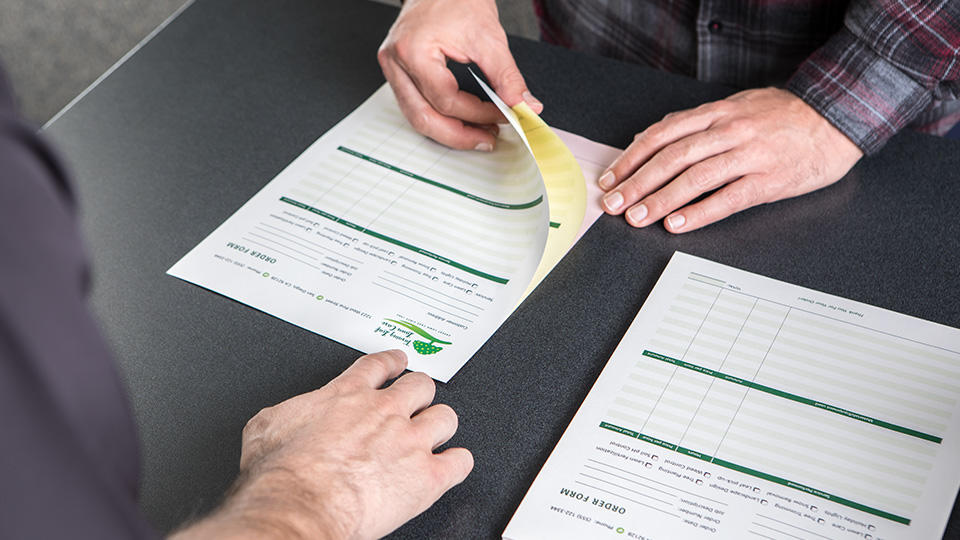 Close up of customers hands inspecting forms