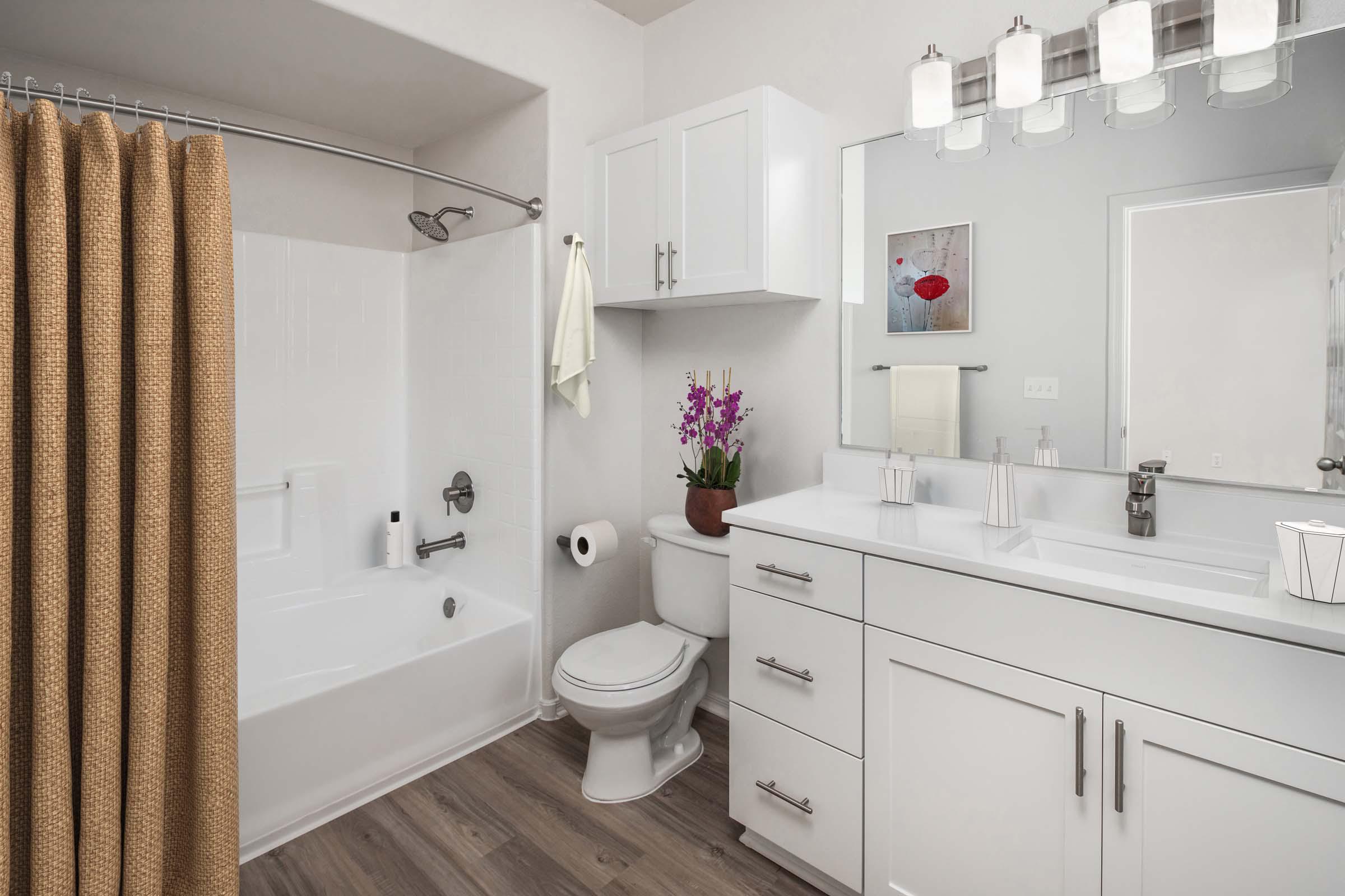 Bathroom with white quartz countertops and nickel fixtures