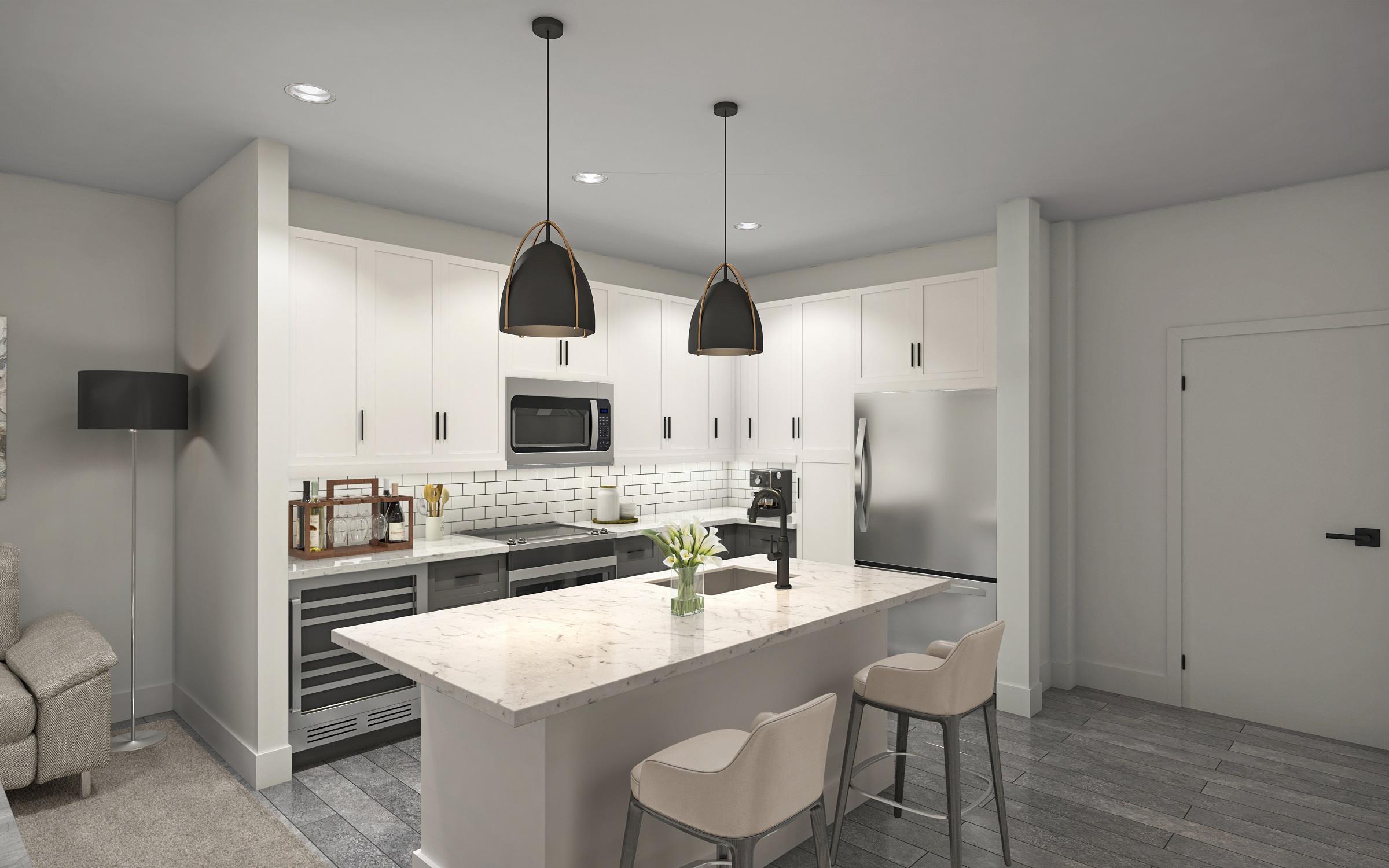 Kitchen with stainless steel appliances and center island with room for seating at Camden Durham