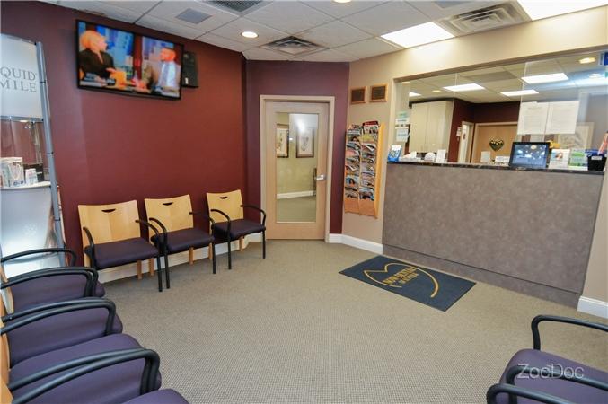 Now Dental of Suffolk patient waiting room with plenty of seats and a TV.