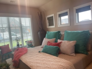 Welcome to this Owasso bedroom! Isn't it fresh and cozy? Part of the effect comes from our Woven Wood Shades, which have an inviting natural look!