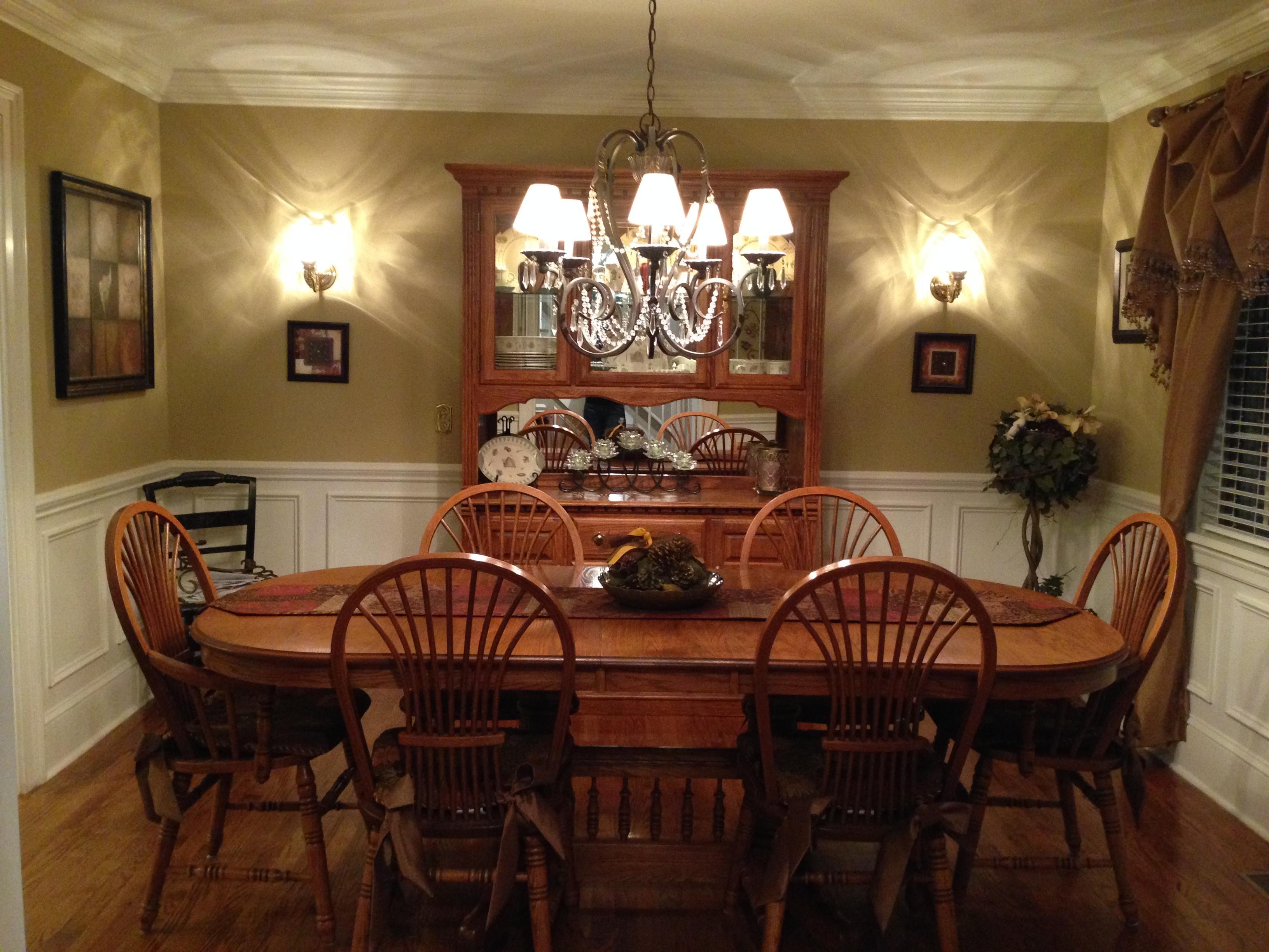Newly remodeled dining room with chandelier and wall sconces