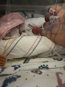 Seiori Sweeney Austin holds mom Paris Sweeney Austin's pinky finger.