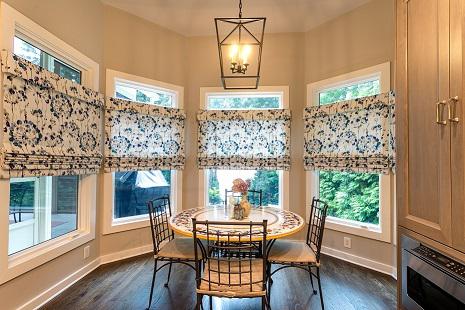 Here's a breakfast nook draped in elegance! Our Roman Shades make a beautiful statement. Let us help you create Shades in the perfect pattern for your decor!