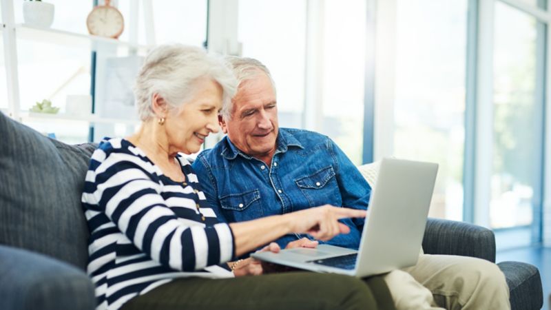 Retired couple surfing the internet on a laptop