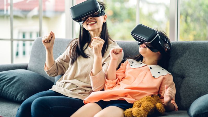 Mother and daughter playing virtual reality on high speed internet