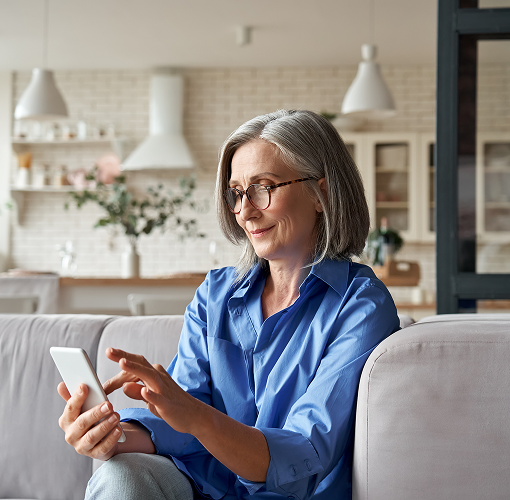Woman in her living room on her phone.