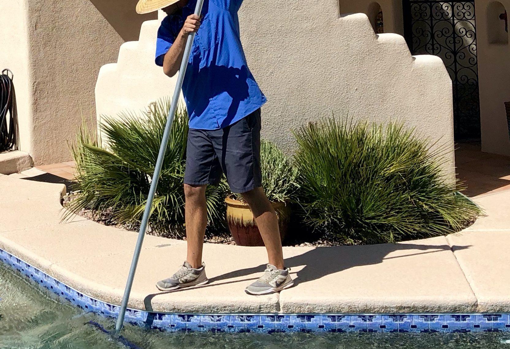Tucson Pool and Spa team member cleaning the pool Tucson Pool & Spa Tucson (520)296-0993