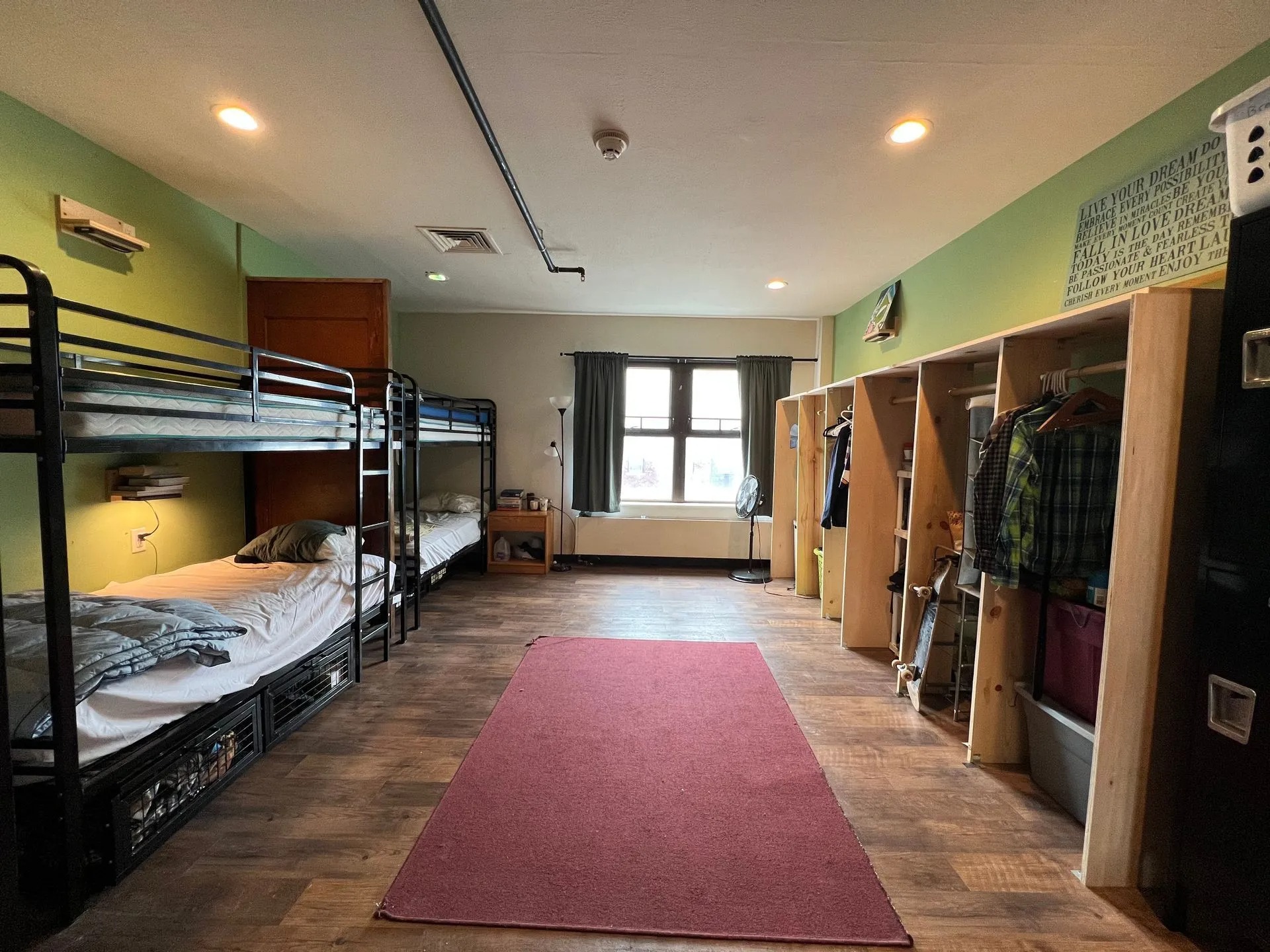 Clean shared living space featuring bunk beds, personal storage, natural lighting, organized furnishings, and comfortable accommodations designed to support structured living, personal responsibility, recovery, and healthy daily routines for residents.