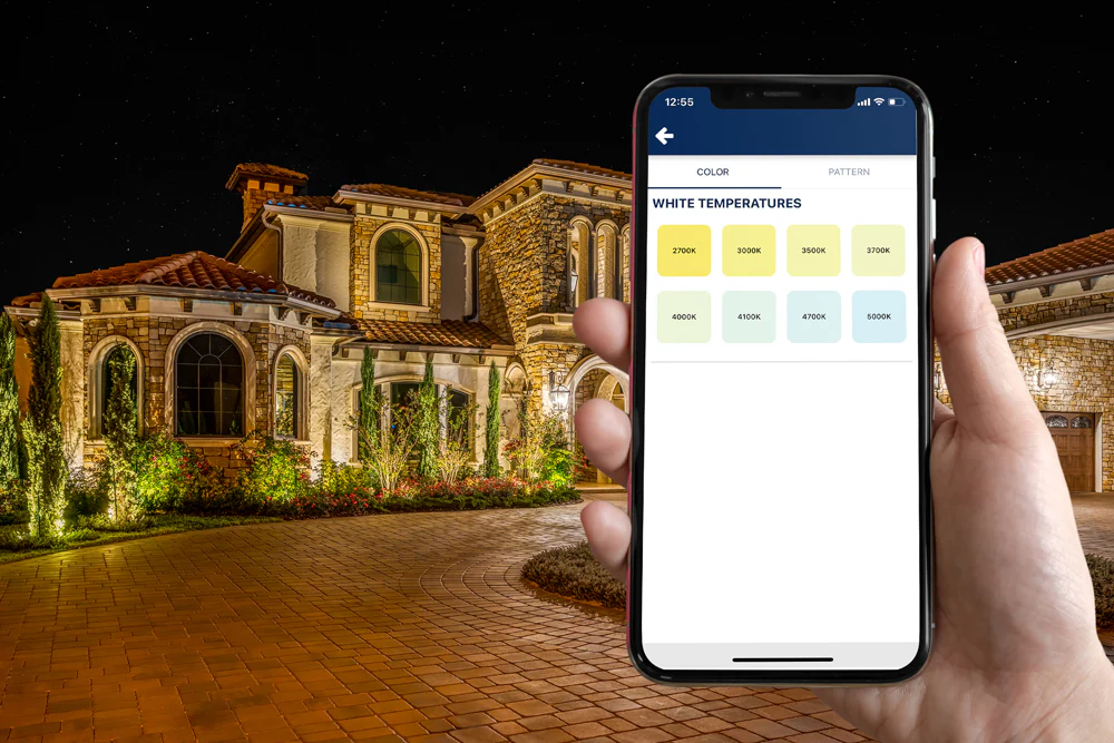 Smart outdoor lighting system shown with mobile app controls for adjusting colors and lighting settings.