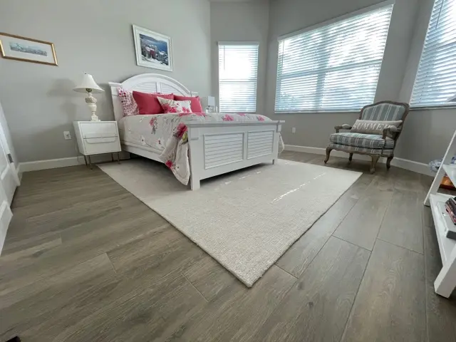 Completed large-format wood-look tile flooring project in a bright residential interior. 