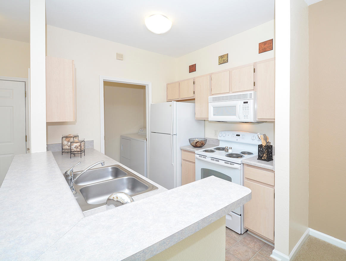 Fully-Equipped Kitchen With White Appliances