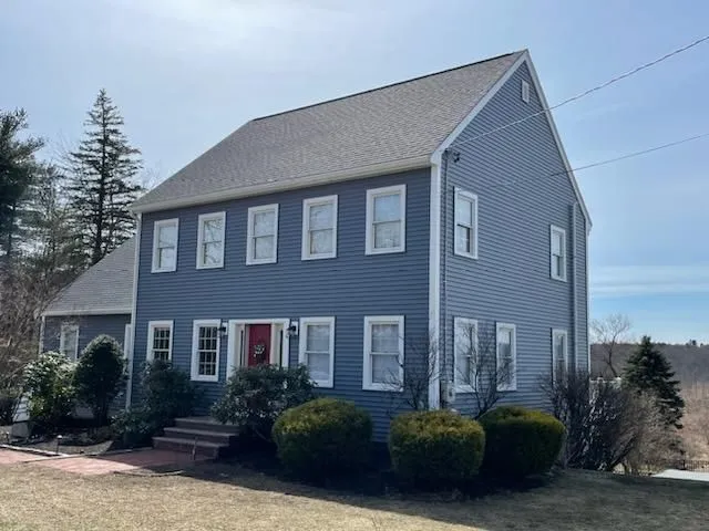 Two-story residential home with seamless gutters, siding, and landscaping. Properly installed gutter 